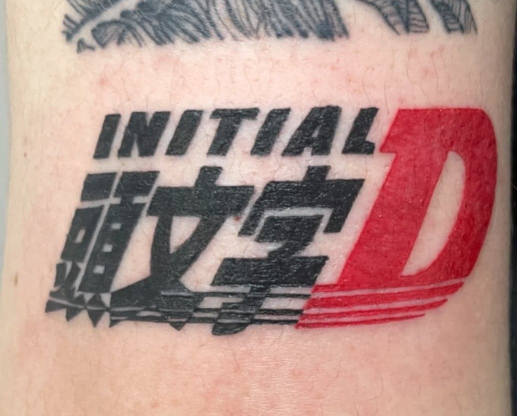 Initial D anime logo in black and red on an arm