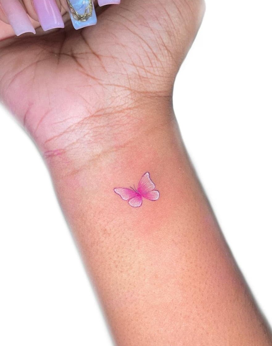 Small soft-pink butterfly on the inside of a wrist