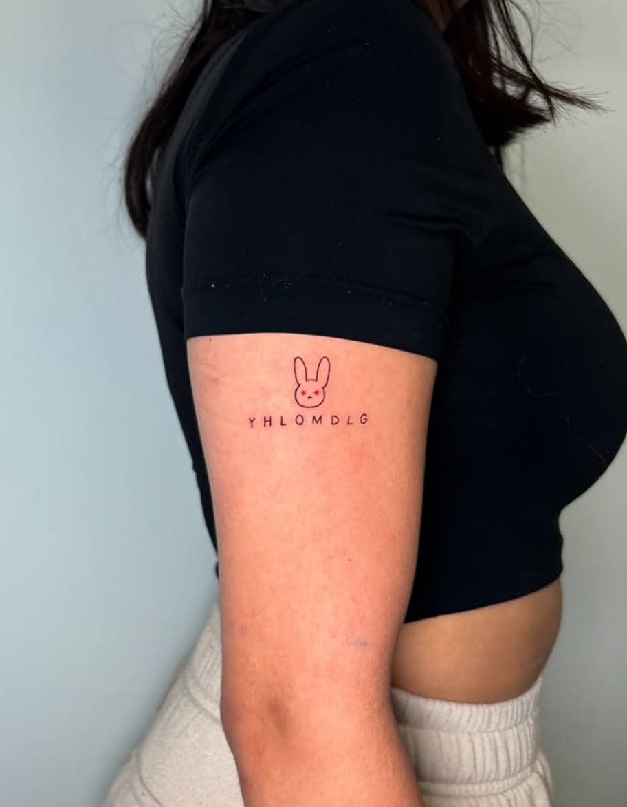 Small red outlined bunny logo with lettering on an upper arm