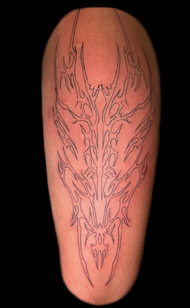 Fine linework stage of a neo-tribal piece, freshly applied